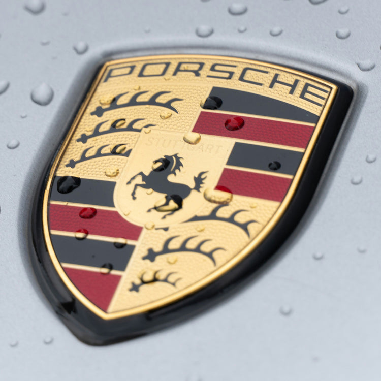 Porsche emblem on silver car